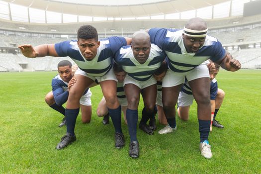 Front view of group of diverse male rugby players ready to play rugby match in stadium