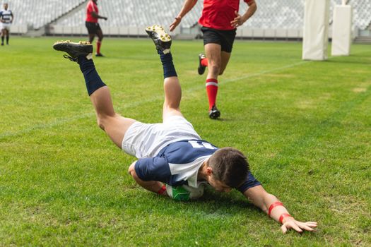 Front view of group of diverse male rugby players playing rugby in stadium