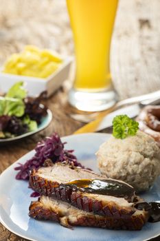 portion of fresh roasted pork on a blue plate