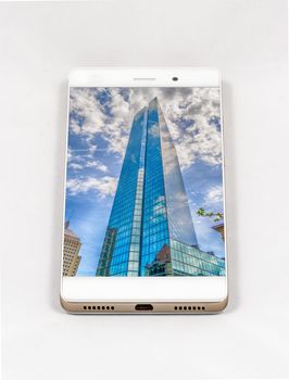 Modern smartphone with full screen picture of a skyscraper in Boston, USA. Concept for travel smartphone photography. All images in this composition made by me, separately available on my portfolio