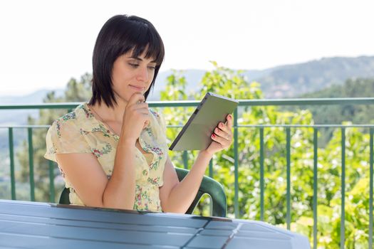 casual woman working with a tablet pc, outdoor