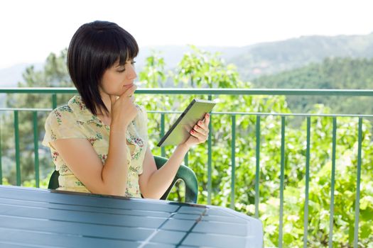 casual woman working with a tablet pc, outdoor