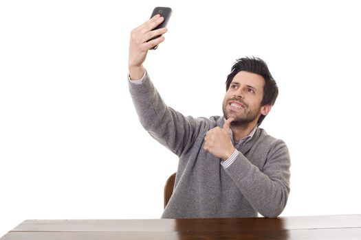 man taking selfie photo with mobile phone camera posing happy and successful isolated on white background