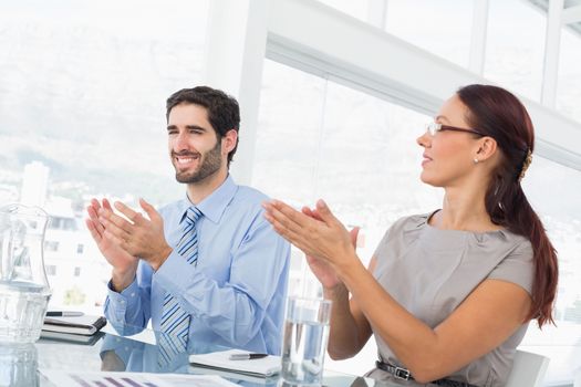 Business people applauding at meeting in work