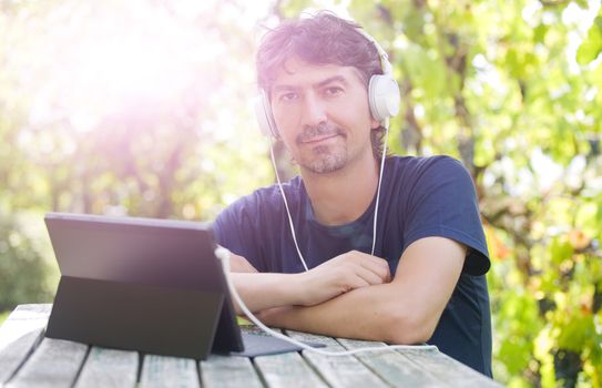 casual man working with a tablet pc, outdoor