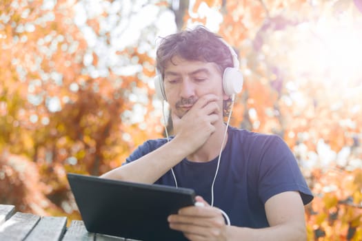 casual man working with a tablet pc, outdoor