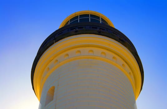 Low angle shot of the top of a lighthouse with the sky in the background