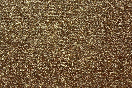 The picture shows a background with golden glittery paper