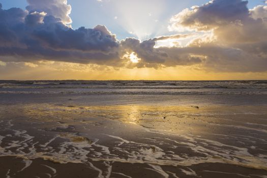 sunset at he north sea at the touristic village of rockanje in holland