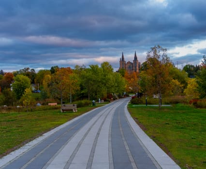 The road to the church through the autumn park at dusk