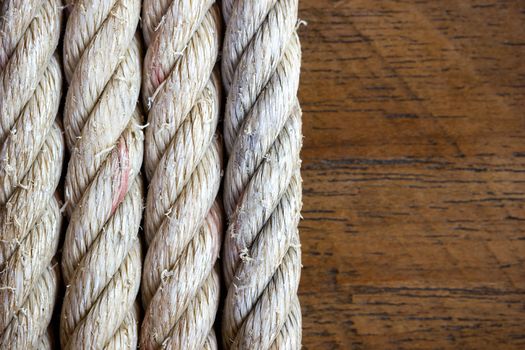 Rope vintage on brown wood background. Closeup and copy space.