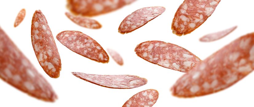Sausage slices levitate on a white background.