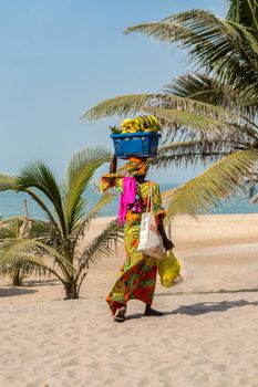 GAMBIE, BIJILO - 05 January 2020;Woman selling fruit in a basket on Bijilo beach in
Gambia