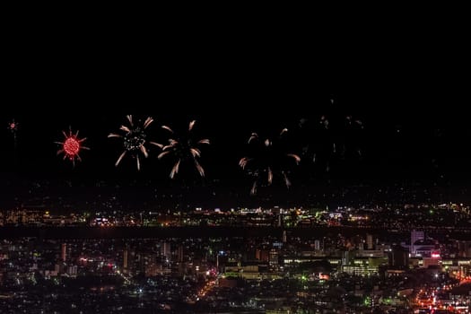 Festive salute in the night sky. Salute over the city the megalopolis. Explosions of fireworks.