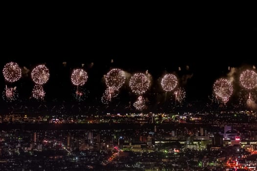 Festive salute in the night sky. Salute over the city the megalopolis. Explosions of fireworks.