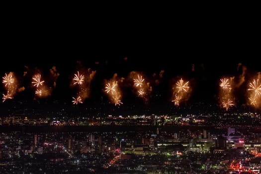 Festive salute in the night sky. Salute over the city the megalopolis. Explosions of fireworks.