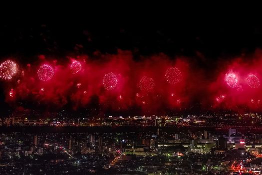 Festive salute in the night sky. Salute over the city the megalopolis. Explosions of fireworks.