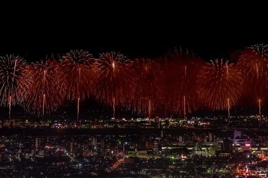 Festive salute in the night sky. Salute over the city the megalopolis. Explosions of fireworks.