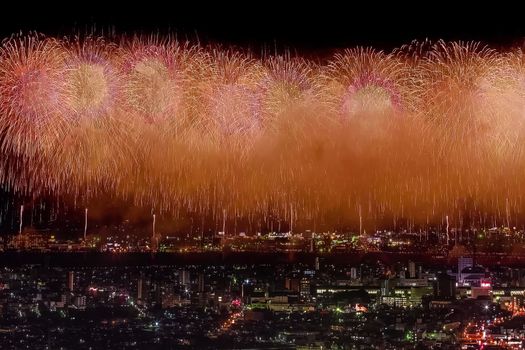 Festive salute in the night sky. Salute over the city the megalopolis. Explosions of fireworks.