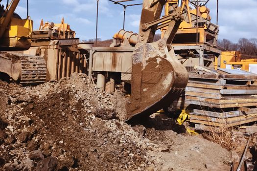 Bulldozer bucket. A bulldozer digs a hole.