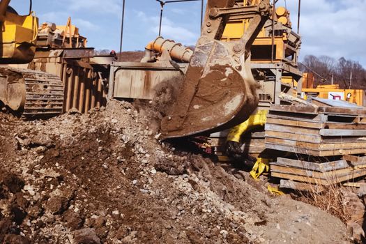 Bulldozer bucket. A bulldozer digs a hole.