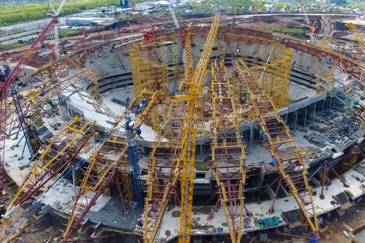 Moscow, Russia - May 12, 2018: Equipment for the construction of the stadium. Tower cranes and construction machinery. Construction of the stadium.