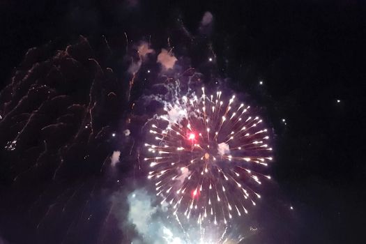 Festive salute in the night sky. Explosions of fireworks.