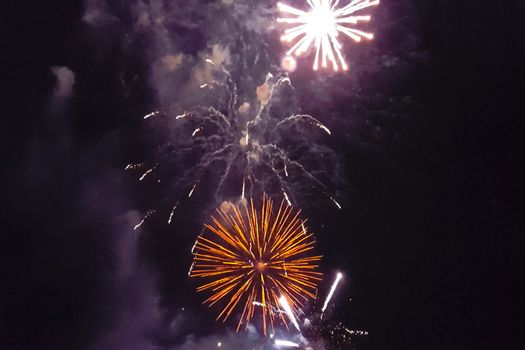 Festive salute in the night sky. Explosions of fireworks.