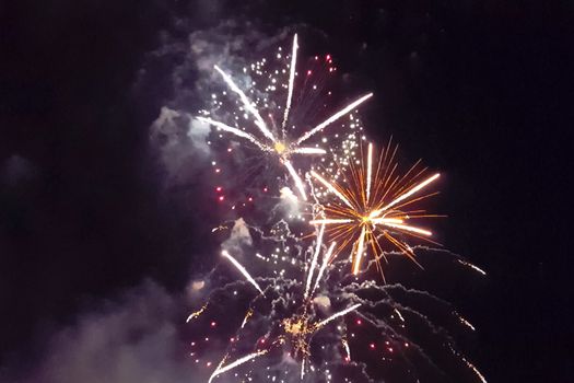 Festive salute in the night sky. Explosions of fireworks.