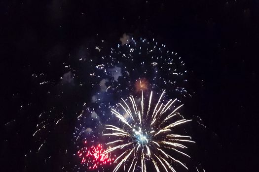 Festive salute in the night sky. Explosions of fireworks.