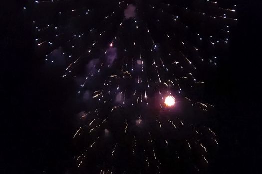 Festive salute in the night sky. Explosions of fireworks.