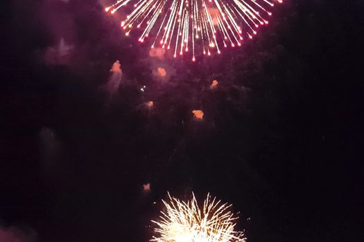 Festive salute in the night sky. Explosions of fireworks.