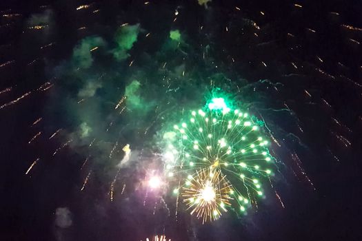 Festive salute in the night sky. Explosions of fireworks.