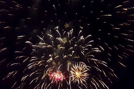 Festive salute in the night sky. Explosions of fireworks.