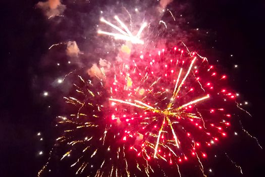 Festive salute in the night sky. Explosions of fireworks.