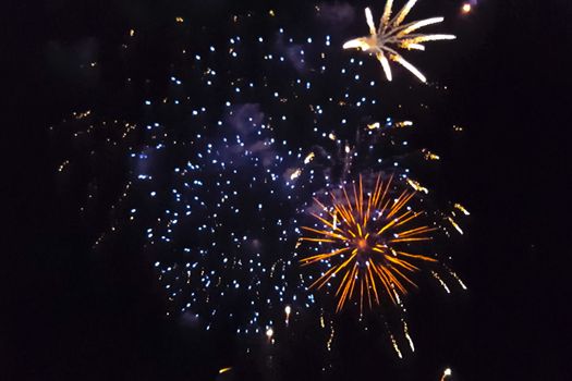 Festive salute in the night sky. Explosions of fireworks.