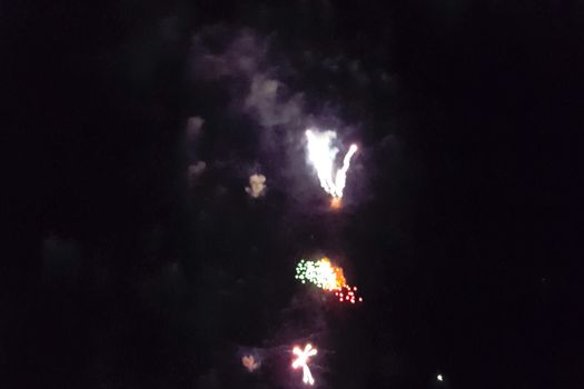 Festive salute in the night sky. Explosions of fireworks.