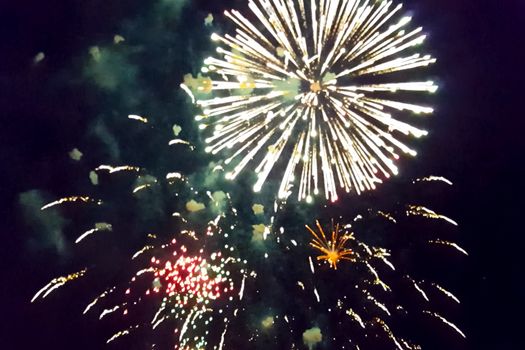 Festive salute in the night sky. Explosions of fireworks.