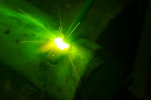 Metal pipe during welding. Sparks and scale.