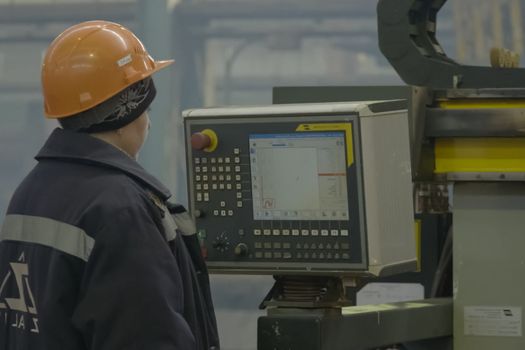 Novorossiysk, Russia - May 26, 2018: Shipbuilding plant, Internal welding workshop m erection of metal structures. The plant in Novorossiysk. Woman operator welding machine at the shipyard.