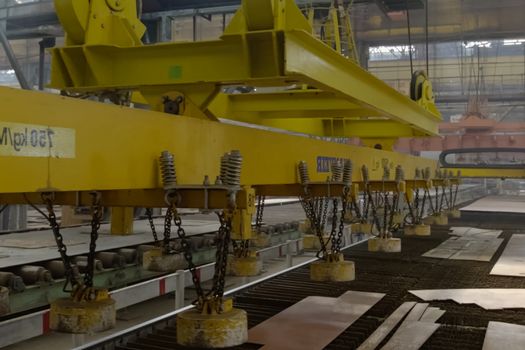 Novorossiysk, Russia - May 26, 2018: Magnetic parts moving in a shipyard. Workplace mechanization. Shipbuilding plant, Internal welding workshop m erection of metal structures. The plant in Novorossiysk.