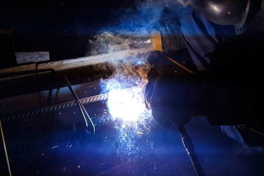 Welding of steel reinforcement. Sparks and light from welding. Electric welding.