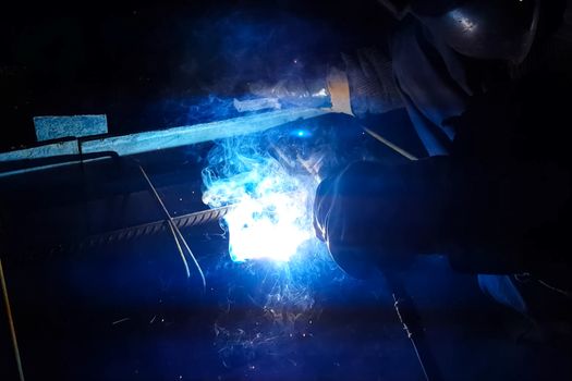 Welding of steel reinforcement. Sparks and light from welding. Electric welding.