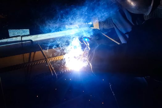 Welding of steel reinforcement. Sparks and light from welding. Electric welding.