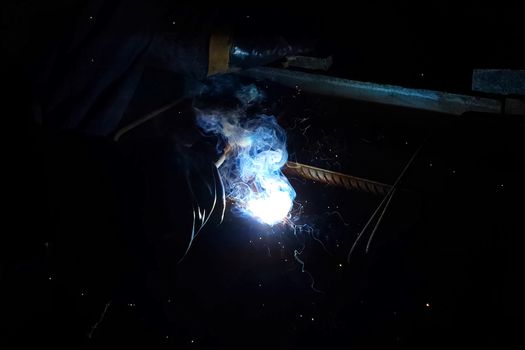 Welding of steel reinforcement. Sparks and light from welding. Electric welding.