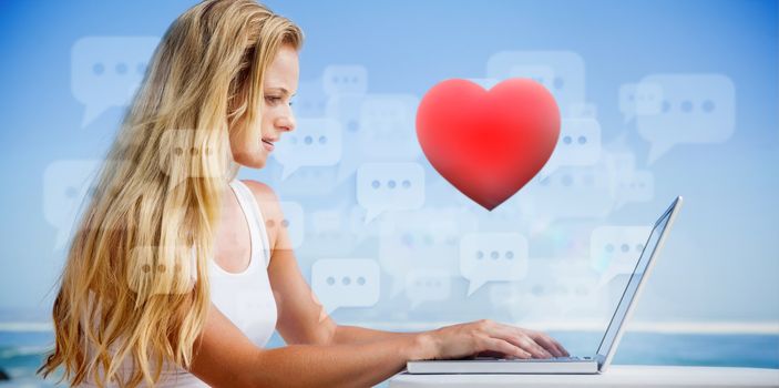 Composite image of pretty blonde using her laptop at the beach against red heart