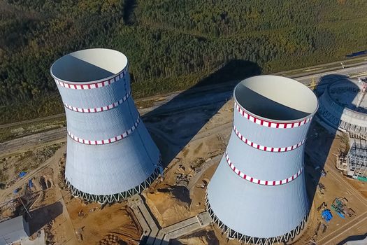 Aerial survey of a nuclear power plant under construction. Installation and construction of a power plant. Nuclear power.