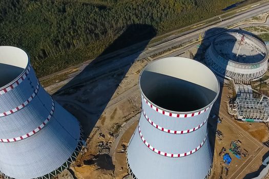 Aerial survey of a nuclear power plant under construction. Installation and construction of a power plant. Nuclear power.