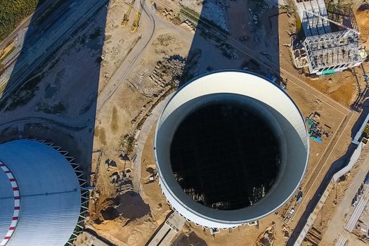 Aerial survey of a nuclear power plant under construction. Installation and construction of a power plant. Nuclear power.