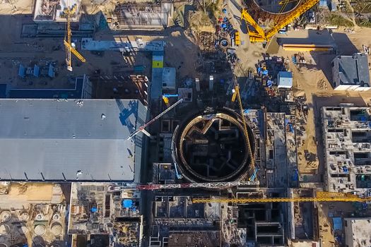 Aerial survey of a nuclear power plant under construction. Installation and construction of a power plant. Nuclear power.